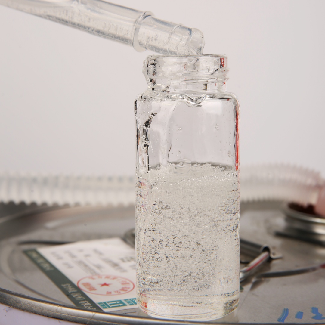 Clear PU glue for EPDM rubber granules being poured into a glass vial