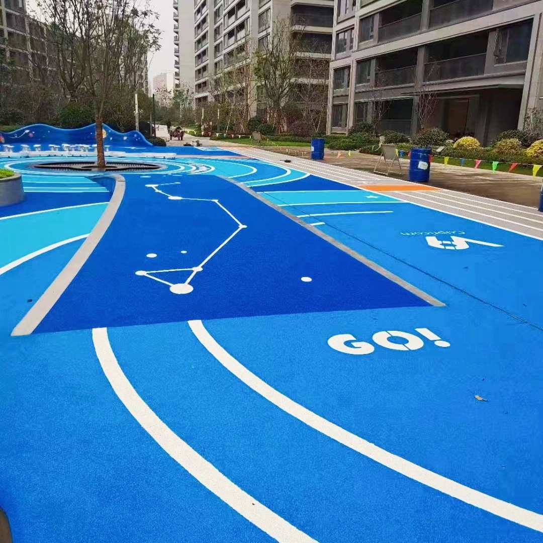 A vibrant blue EPDM granule playground surface featuring white curved lane lines, constellation patterns, and the word “GO!” — designed for children’s recreational and motor skill development