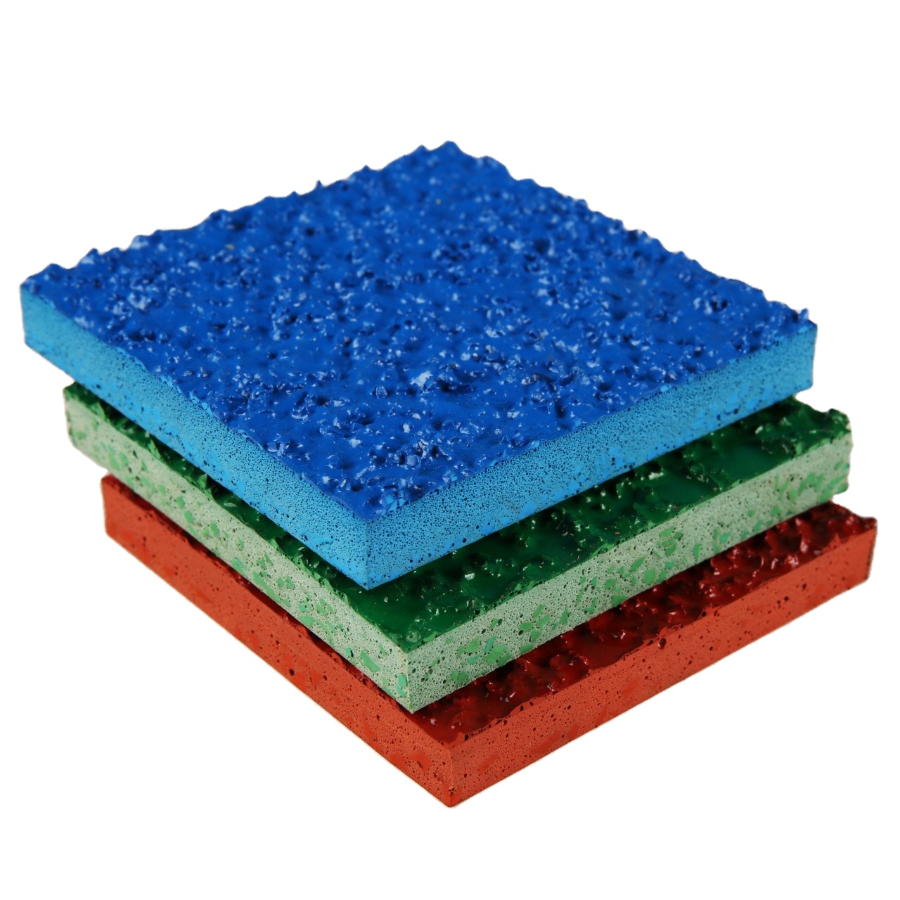 Stacked samples of porous rubber flooring tiles in blue, green, and red, showcasing the textured surface and thickness of the material.